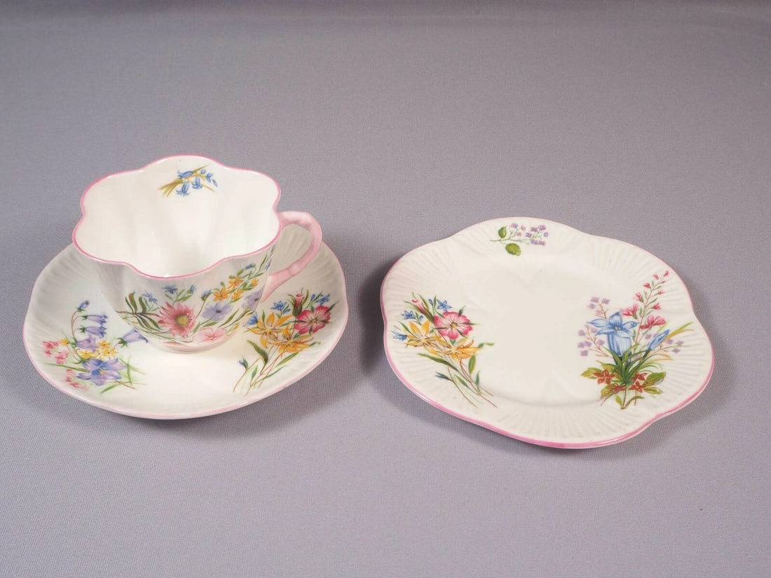 Shelley WILD FLOWERS Dainty Shape Tea Coffee Cup Saucer Plate TRIO Bone China: This is a beautiful and timeless Fine Bone China Tea/Coffee Cup, Saucer and Dessert Plate TRIO, made by Shelley England in Wild Flowers pattern. The set is in the Shelley famous Dainty shape with pink