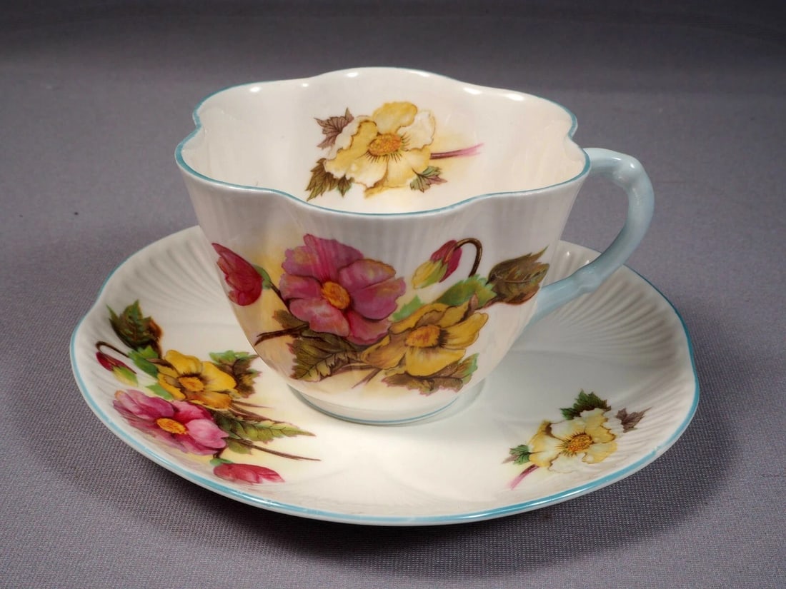 Shelley Begonia Dainty Shape Tea Coffee Cup Saucer Set Bone China: This is a beautiful and timeless Fine Bone China Tea/Coffee Cup and Saucer Set, made by Shelley England in the famous Begonia pattern. The set is in the Shelley famous Dainty shape. It is properly mar
