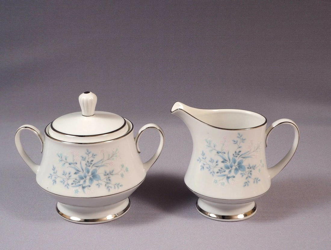VINTAGE NORITAKE CAROLYN Creamer Milk Jug Cover Sugar Bowl SET Silver Platinum: This very beautiful Covered Sugar Bowl and Creamer/Milk Jug Set is made by Noritake in Carolyn pattern. The pattern was made around between 1970 and 1994s. The pattern has blue and white flowers, silv