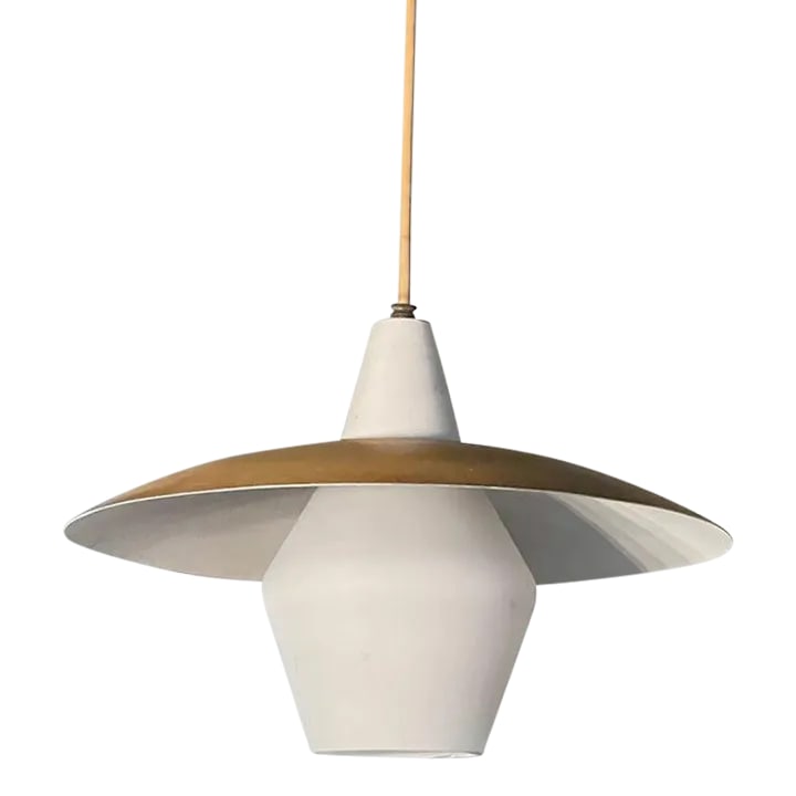 Mid Century Modern Intersecting Disc Pendant Light: Mid century modern pendant light features a frosted glass lantern shade with an intersecting metal disc with gold exterior and white interior in the style of Gerald Thurston, Lightolier. The pendant