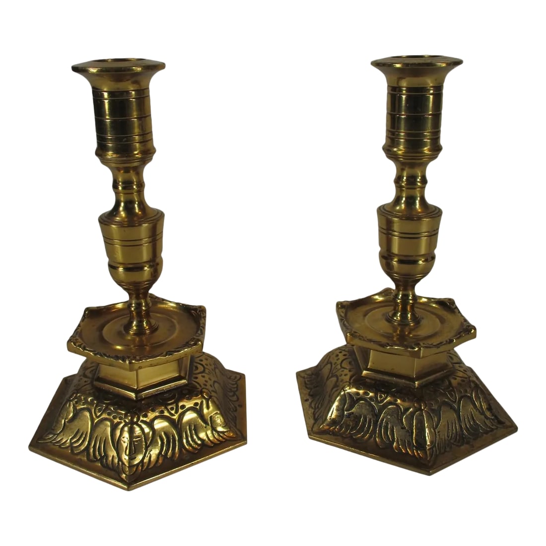 Pair of Mid 20th Century Ystad Metall Candle Holders in Solid Brass, Sweden: A pair of Ystad Metall Candleholders, made in Sweden from heavy solid brass. They feature incredible scrolling and intricate detailing has a golden tone to the brass Ystad Metall is a famous brass