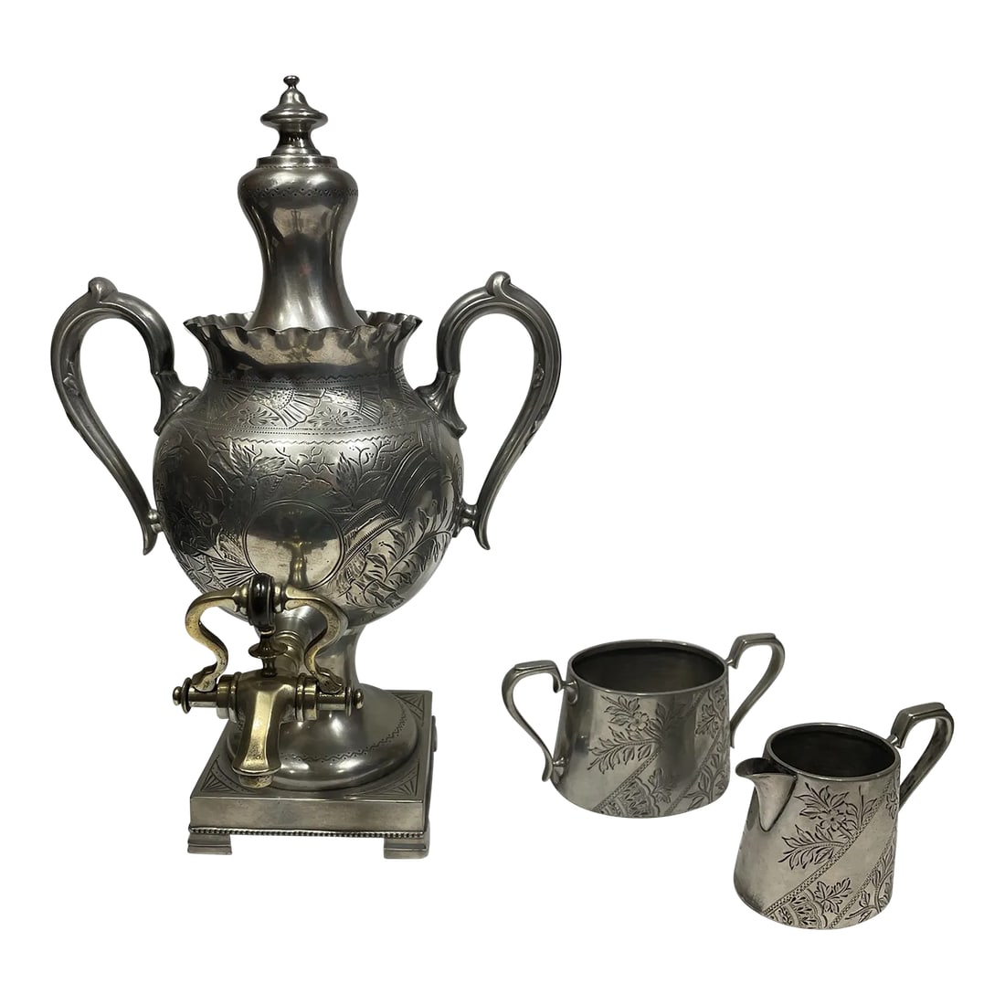 Late 19th Century English Pewter Tea Service- 3 Pieces: Dating to 1870 and made in Sheffield, England, a locale well known for its silver design and production, this is an extremely well-preserved three-piece pewter and brass tea service. It consists of a