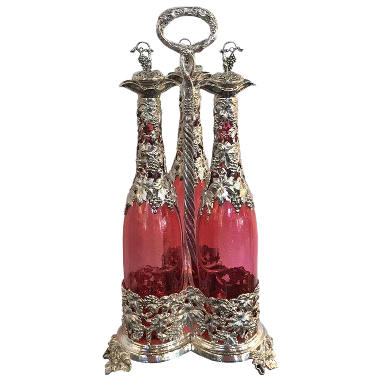 19th Century English Silver Plate and Cranberry Glass Three-Bottle Tauntless: Stunning English Silver Plate And Cranberry Glass Three-Bottle Tauntless, With Tall Cranberry Glass Decanters Dripping With Applied Silver Work Of Grapes And Vines. Fitted In An Conforming, Elaborate 