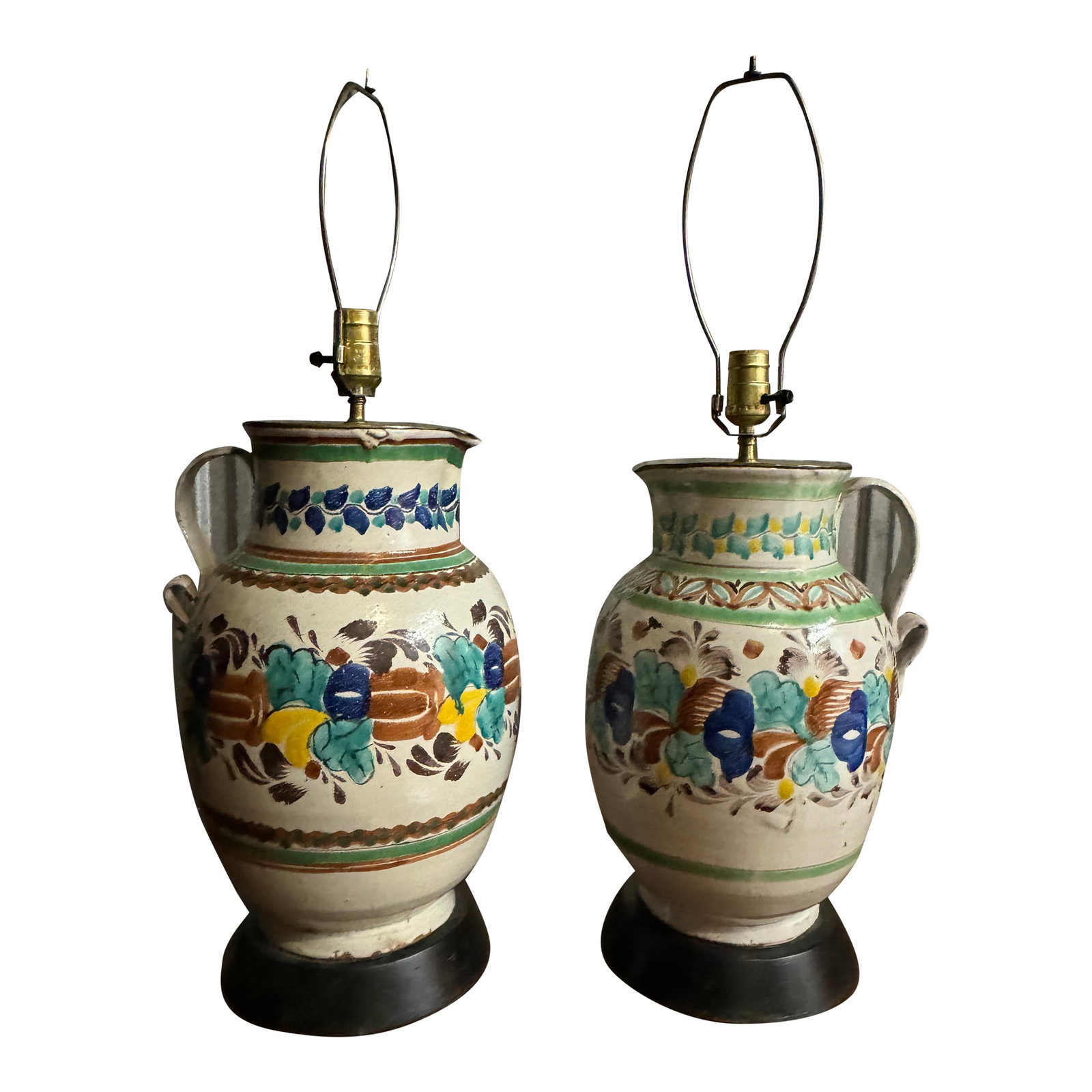 Vintage 1960s Colorful Mexican Pitcher Table Lamps - Set of 2: Brighten up your space with this vibrant set of two Vintage 1960s Mexican Pitcher Table or Desk Lamps. Handcrafted from ceramic, each lamp features a classic pitcher silhouette adorned with bold,