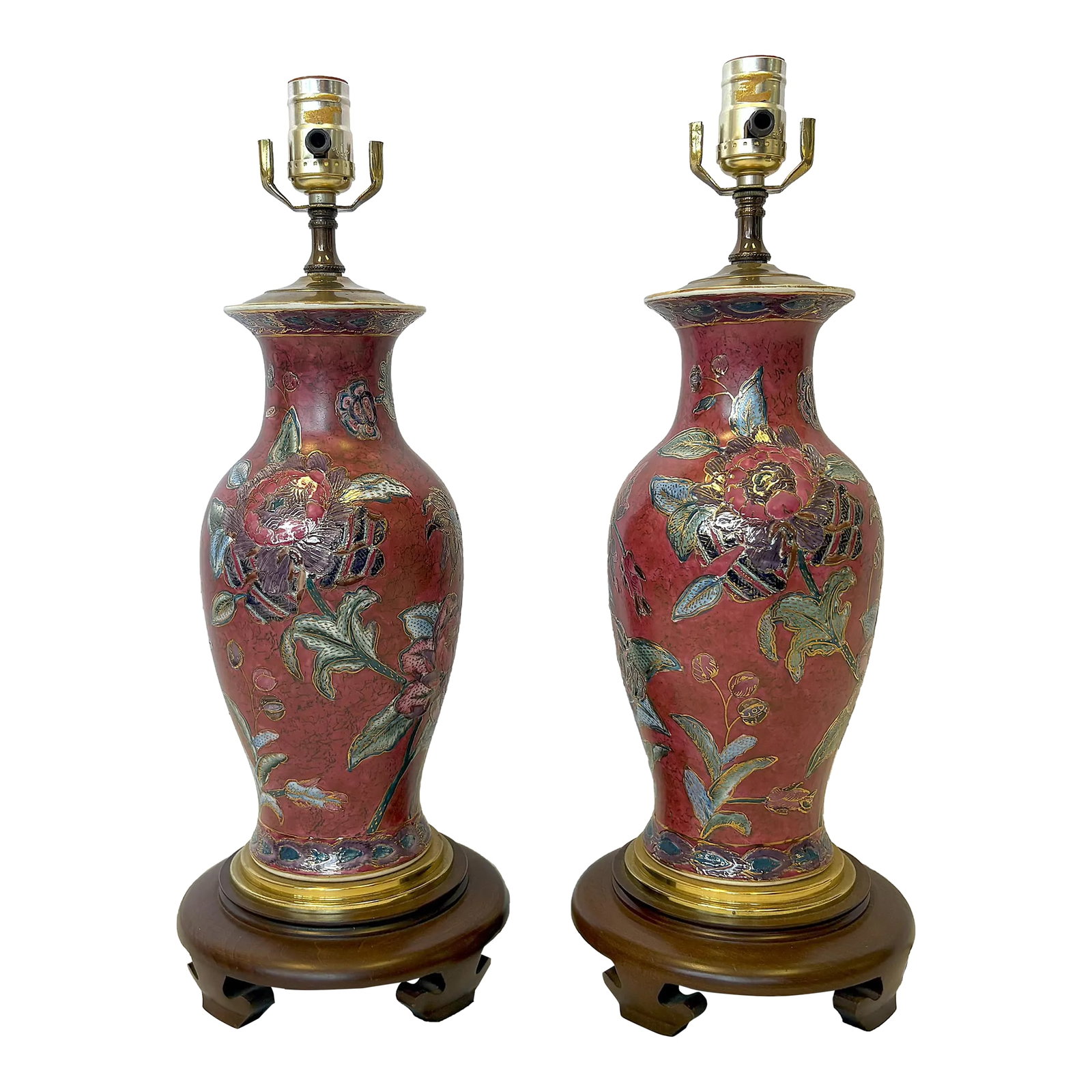 Vintage Ceramic Vase Lamps With Elegant Floral Design on Wood Plinths- A Pair: A stylish pair of ceramic table lamps. The ceramic vases are painted in a Chinoiserie style with floral designs in shades of burgundy, blue and gold. They have been made into lamps with a brass top