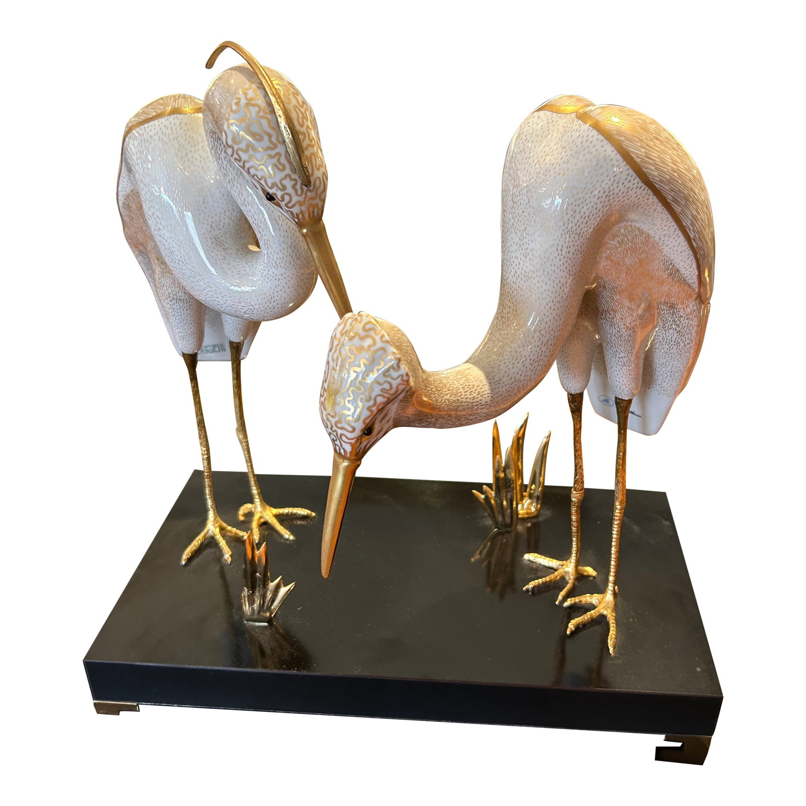 Giulia Mangani for Ogetti Porcelain & Gilded Brass Herons on Black Platform: Superb sculpture by Giulia Mangani for high end Italian decor company Ogetti, having labels on the piece. Two beautifully posed gilded and porcelain decorated herons with detailed brass feet stand on