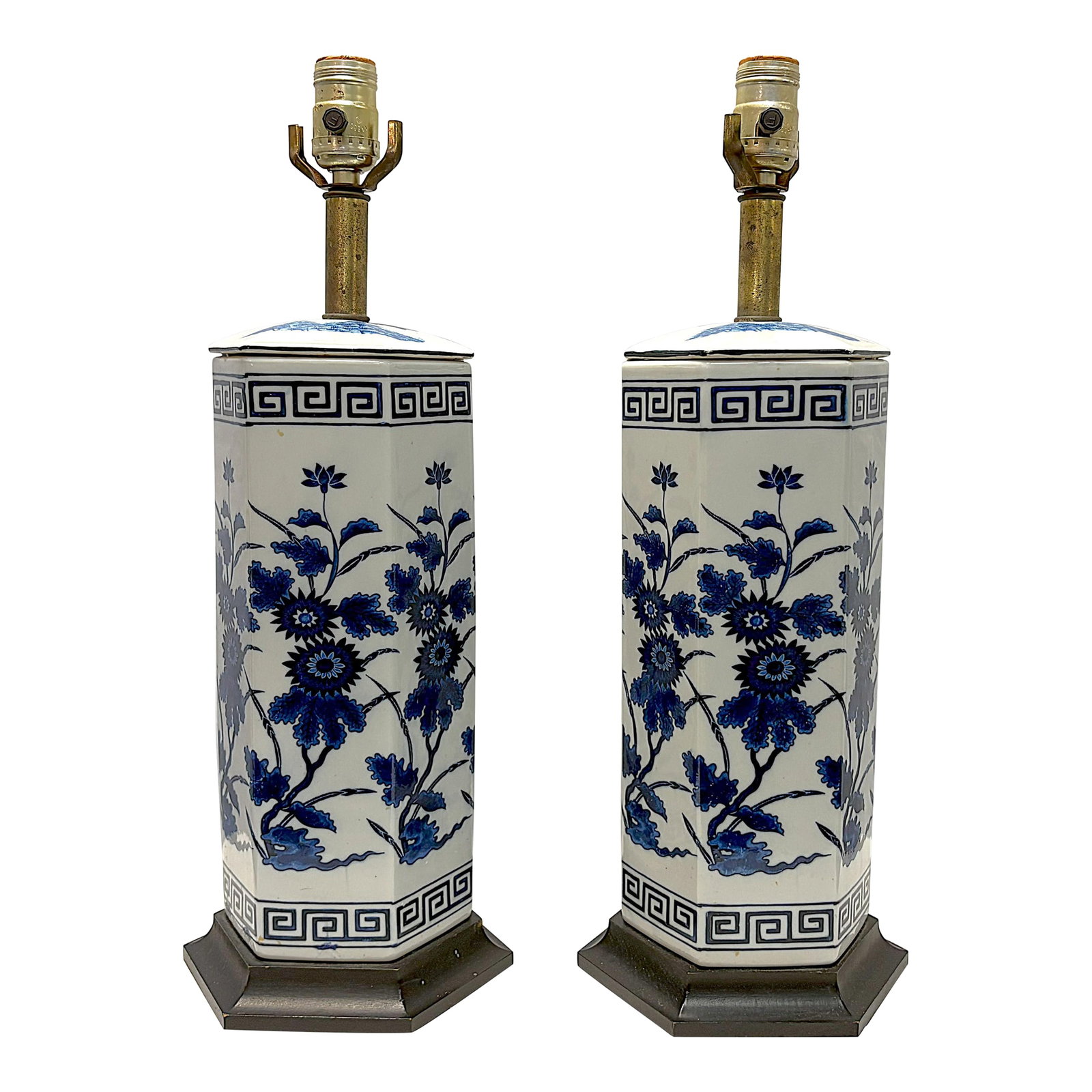 Vintage Mid Century Blue and White Ceramic Hexagon Shaped Table Lamps- A Pair: Attractive pair of ceramic table lamps from the late 20th century. They are made of white ceramic in a hexagon shape and sit on black painted wood plinths. The lamps are painted with blue and white