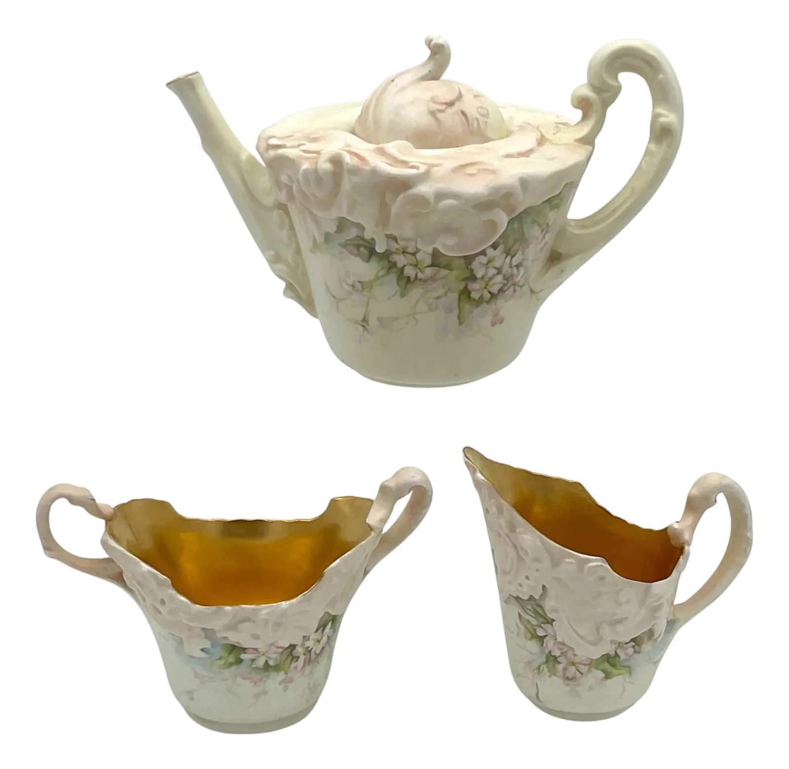 Doulton Burslem Blush Ivory 3 Piece Tea Set with Apple Blossom Decoration, 1889: Doulton Burslem Blush Ivory Three-Piece Tea Set with Apple Blossom Decoration, 1889 England, Dated by Registration to 1889 Teapot: 8" W x 5.5" H x 5" D Creamer: 4.5" W x 4" H Sugar: 6" W x 3.75" H An