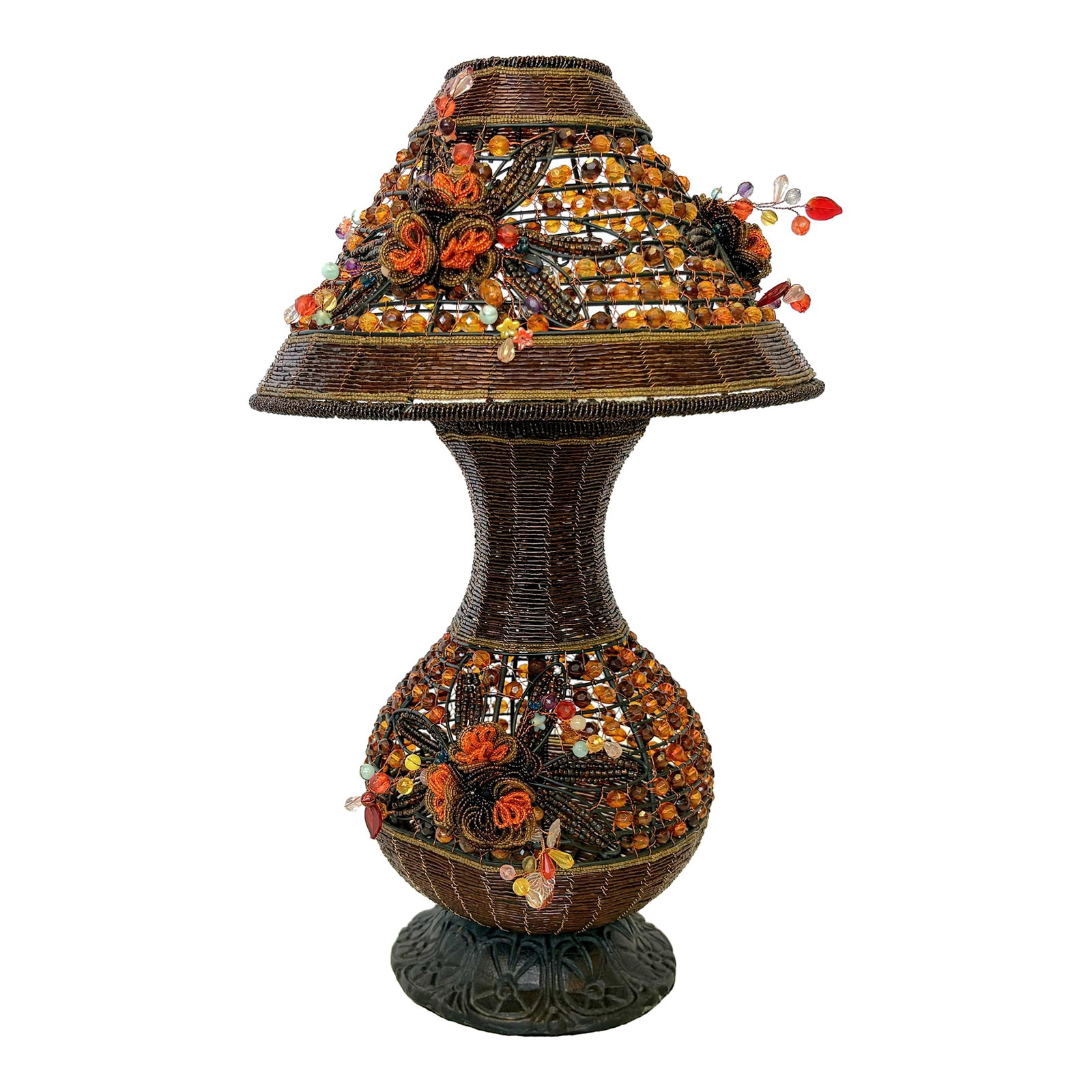 Vintage Beaded Tramp Art Table Lamp With Floral Embellishments: Precious vintage beaded table lamp from the late 20th century. The lamp his hand made with amber and orange colored beads in a tramp art style with a sturdy metal base. There are wonderful beaded