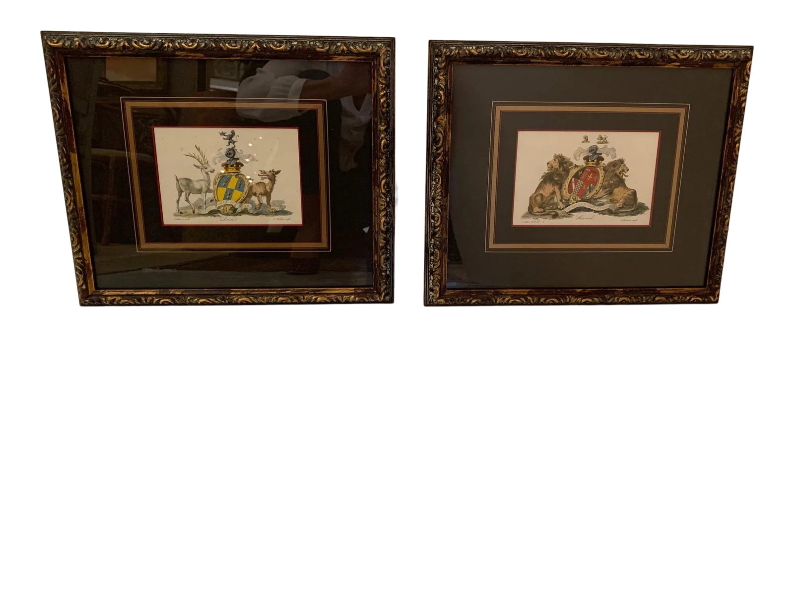 Colored Etchings With Royal Shield Motife -A Pair: Beautifully framed pair of colored etchings having a regal feel with royal shields flanked by lions, elk and such. Condition: Alterations: Original Condition Unaltered Imperfections: Some