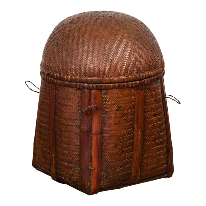 Antique Thai Hand Woven Rattan Basket with Domed Lid & Rustic Character: An antique rustic Thai hand woven rattan basket from the early 20th century, with domed lid, bamboo braces and brown patina. Created in Thailand during the early years of the 20th century, this