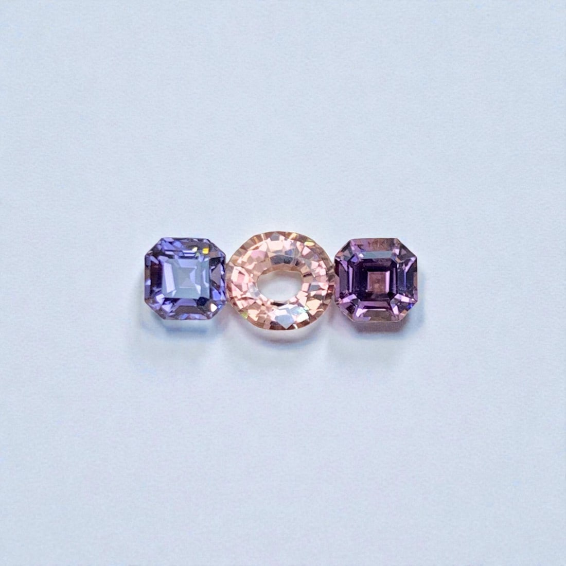 Orange Sapphire Stone with Reverse pair Spinel Gemstones: Orange Sapphire Stone with Reverse pair Spinel Gemstones Weight (CT) : 2.10 Measurements(MM) : 5.5 x 5 x 3.5 , 3.2 x 3.2 Shape : Oval / square Color : Orange, Blue, Purple Treatment : None Clarity :