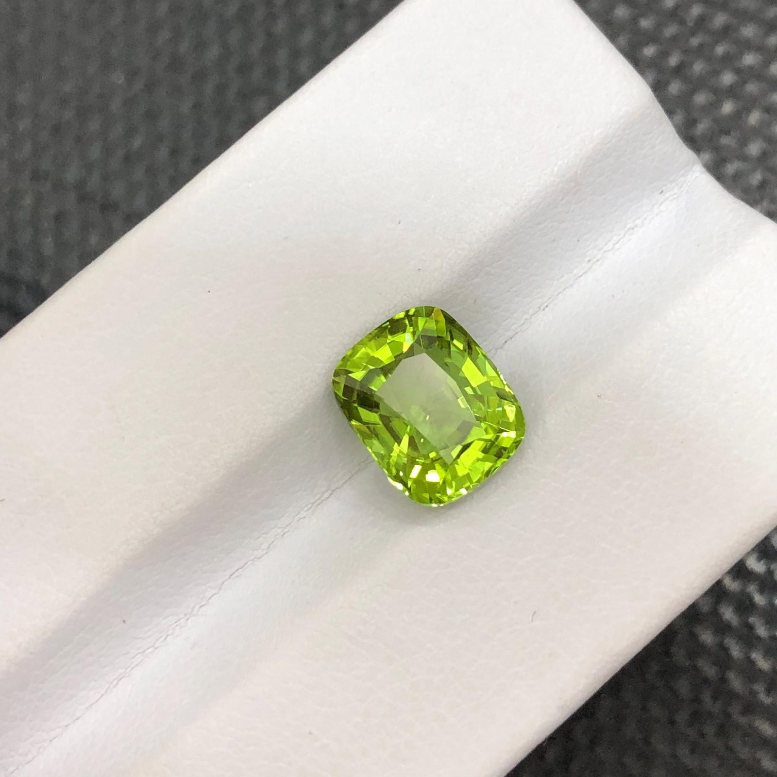 Natural Peridot Gemstone: 3.80 Carat Apple Green Cushion Cut: Gemology: * Weight : 3.80 carat * Dimension : 9.8*8*5.9 mm * Color : Apple Green * Clarity : Loupe Clean * Shape : Cushion Cut * Hardness : 6.5 - 7 * Mineral Class : Olivine * Mine: Sapat * Origin :