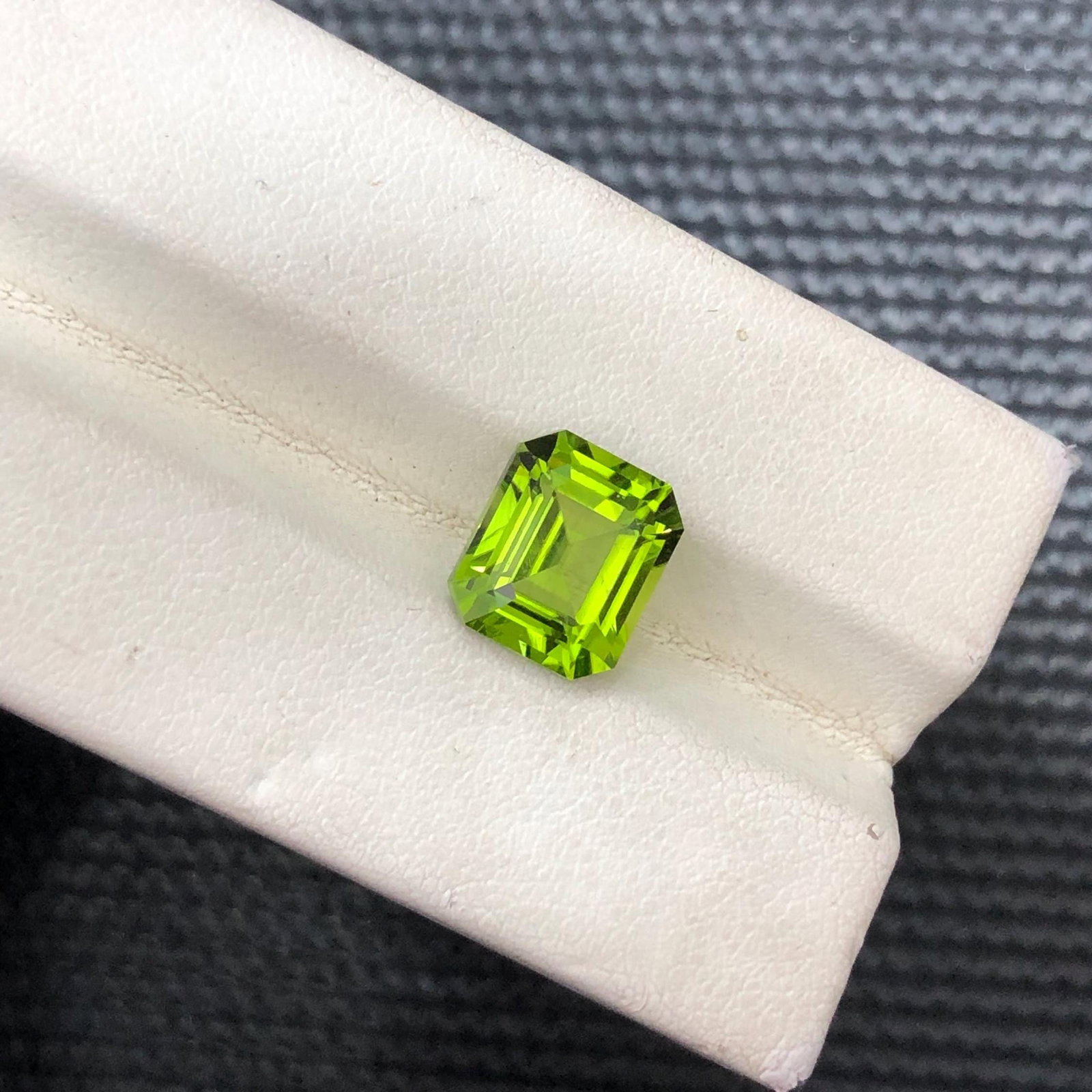 3.16 Carat Emerald Cut Peridot Gemstone: Apple Green Jewelry Stone: Gemology: * Weight : 3.16 carat * Dimension : 9.4*7.1*5.8 mm * Color : Green * Clarity : SI * Shape : Cushion Cut * Hardness : 6.5 - 7 * Mineral Class : Olivine * Mine: Sapat * Origin : Pakistan * Lus
