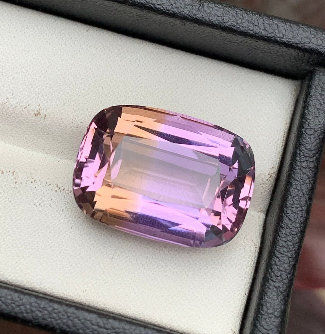 Cushion Cut Ametrine Gemstone: Bi-Color Purplish Yellow, 22.60 CT: Discover the allure of our exquisite log cushion-cut natural purplish orange ametrine loose gemstone. Radiating warmth and sophistication, this gem is a flawless choice for statement and custom jewelr