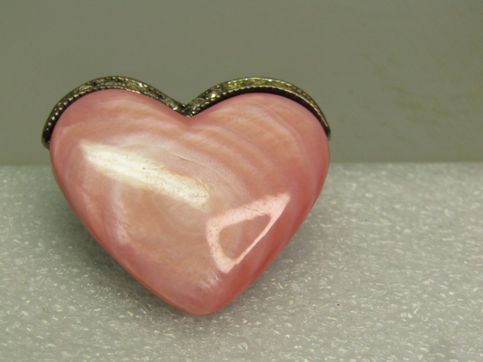 Vintage Pink Heart Brooch, MOP and Rhinestone Brooch, Signed Monet, 1980's.: Vintage Pink Heart Brooch, MOP and Rhinestone Brooch, Signed Monet, 1980's. The front is a pink dyed mother-of-pearl heart with a silver tone top with clear rhinestones and silvertone back with