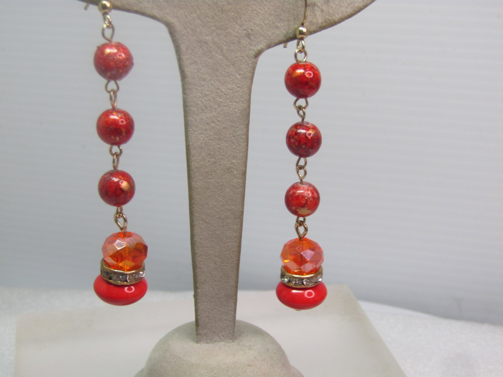 Vintage Orange AB Faceted Glass Rondelle Earrnigs, Drop Beaded, 1970's-1980's: Vintage Orange AB Faceted Glass Rondelle Earrnigs, Drop Beaded, 1970's-1980's. Gold tone hook posts with three 7.5mm round faux agate beads that are orange with gold accents throughout. On the bottom