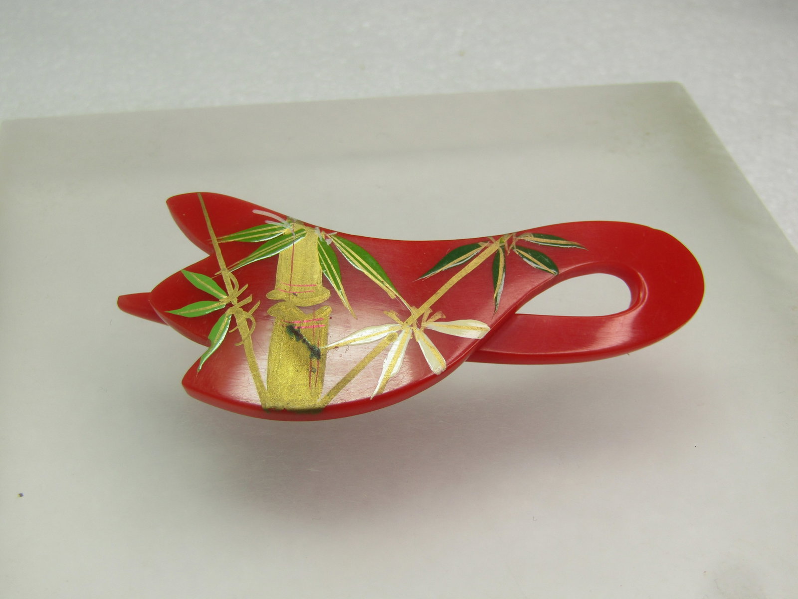 Vintage Asian Themed Slide Barrette, Enameled Bamboo, Red 1960's-1970's: Vintage Asian Themed Slide Barrette, Enameled Bamboo, Red 1960's-1970's. This is chery red plastic with a slide design to slip over a small amount of hair. It has a pointed top that is appx. 1-1/8"