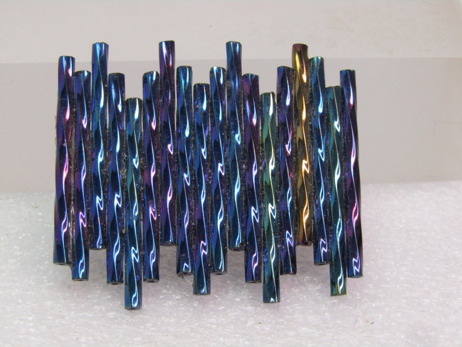 Handmade Peacock Glass Straw Bead Brooch: Handmade Peacock Glass Straw Bead Brooch. The makers look at these beads as a reflection fo the Northern Lights withe the shimmering purples, blues, green, and golden colors. The exact age is unknown