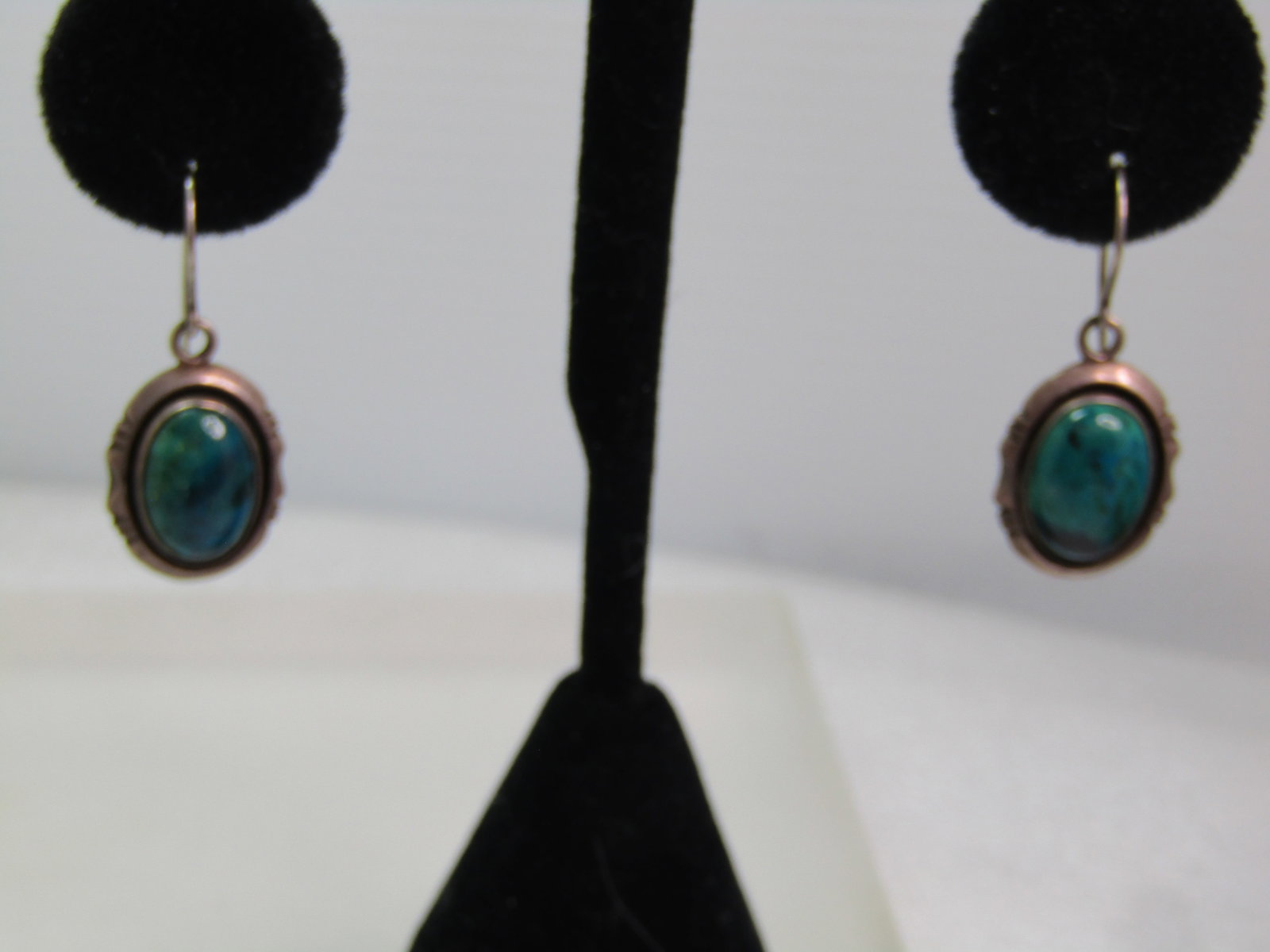 Vintage Sterling Southwestern Chrysocolla Earrings, Pierced, Drop, 1970's-1980's Signed: Vintage Sterling Southwestern Chrysocolla Earrings, Pierced, Drop, 1970's-1980's Signed TG. TG is Teddy Goodluck The stones are believed to be chrysocollar and are bezel-set oval cabochons that are