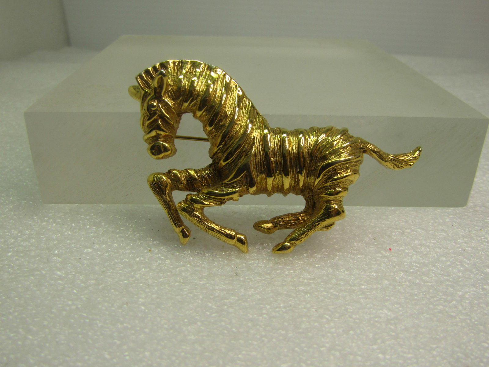 Vintage Zebra Brooch, Gold Tone, 1970's-1980's: Vintage Zebra Brooch, Gold Tone, 1970's-1980's. Textured and smooth finish detailing the stripes of the zebra. It is appx. 2.5" wide and 1.5" tall. Very clean and in very good condition. It is not sig