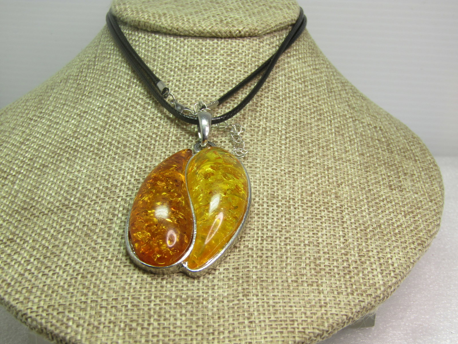 Faux Two-Toned Amber Necklace, 24"-26", 1990's: Faux Amber Necklace, 24"-26", 1990's or slightly after. Two shades of amber - honey and yellow in a pendant with swing back. The pendant is appx. 2.5" tall and 1.5" wide. The necklace is a 2mm black
