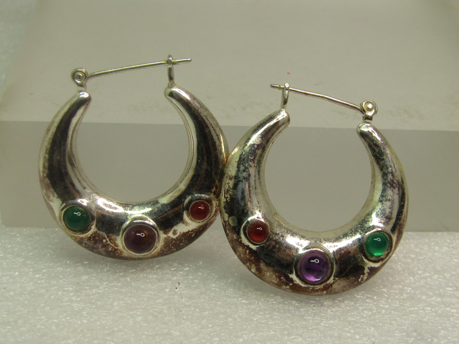 Silver Plated Hoop Earrings with Three Stones, Pierced, 1980's-1990's: Silver Plated Hoop Earrings with Three Stones, Pierced, 1980's-1990's. These have hinged posts and do have magnetic reation. They have stones in the colors of ruby, amethyst, and emerald that are