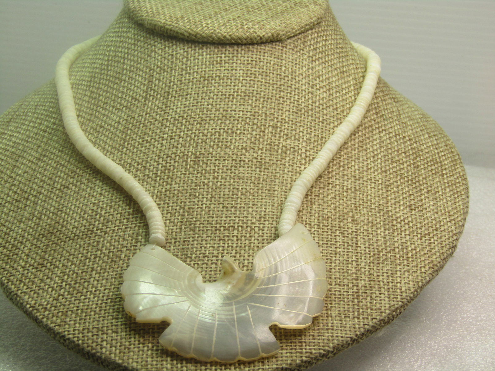 Vintage Carved Dove Mother-of-Pearl Necklace, Puka, 18.5", 1960's-1970's: Vintage Carved Dove Mother-of-Pearl Necklace, Puka, 18.5", 1960's-1970's. This has a carved dove as the pendant - mother-of-pearl and appx. 2" tall and 2-3/8" wide. The puka beads are appx. 4.5mm