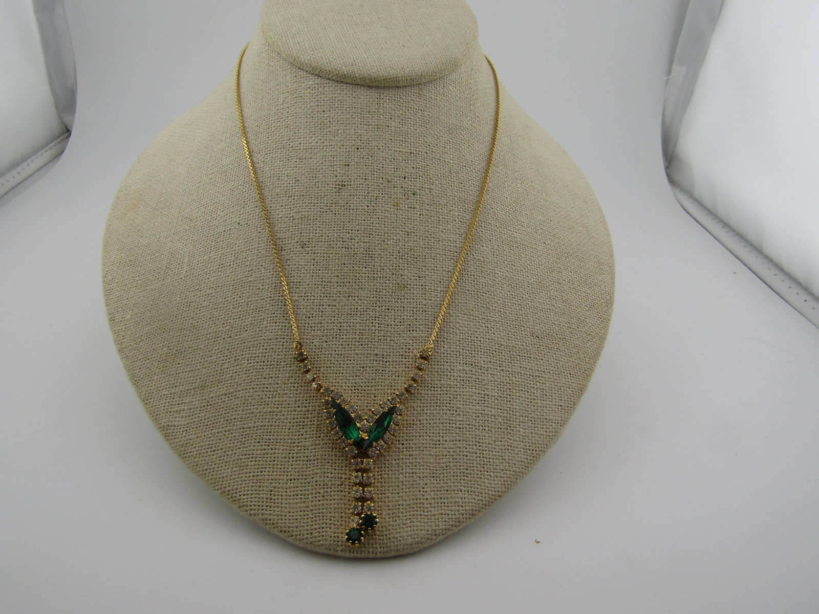 Vintage Green/Clear Rhinestone Drop V Necklace, 17", 1980's: Vintage Green/Clear Rhinestone Drop V Necklace, 17", 1980's. Emerald green glass/crystal rhinestones in a V drop with dangles. There are two emerald green prong-set long navettes and a round stone on