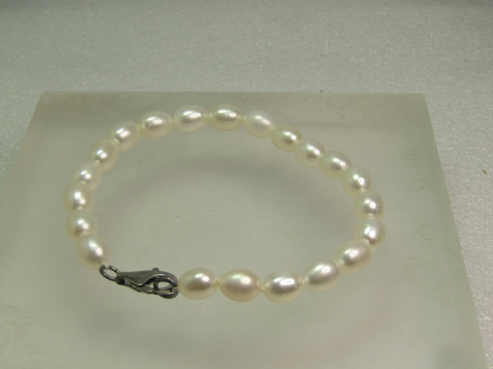 Oblong Pearl Bracelet, 8", Sterling Clasp. 1980's-1990's: Oblong Pearl Bracelet, 8", 1980's-1990's. This has a sterling silver lobster clasp - marked .925 and tests as silver tone lobster clasp. The pearls are believed to be cultured but not sure. They are a