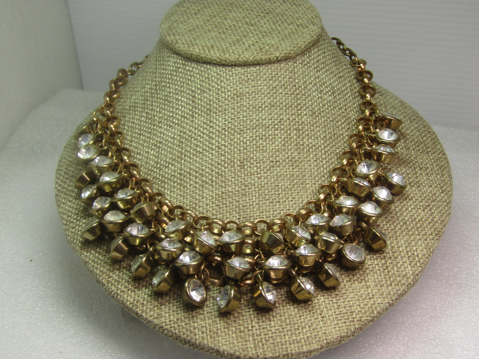 Vintage Four Strand Rhinestone Bib Necklace, Chain Mail Style, 22.5", 1980's: Vintage Four Strand Rhinestone Bib Necklace, Chain Mail Style, 22.5", 1980's. This is gold tone with closed backs like the 7.5mm clear stones are set into little cups. This has a roloe link for the