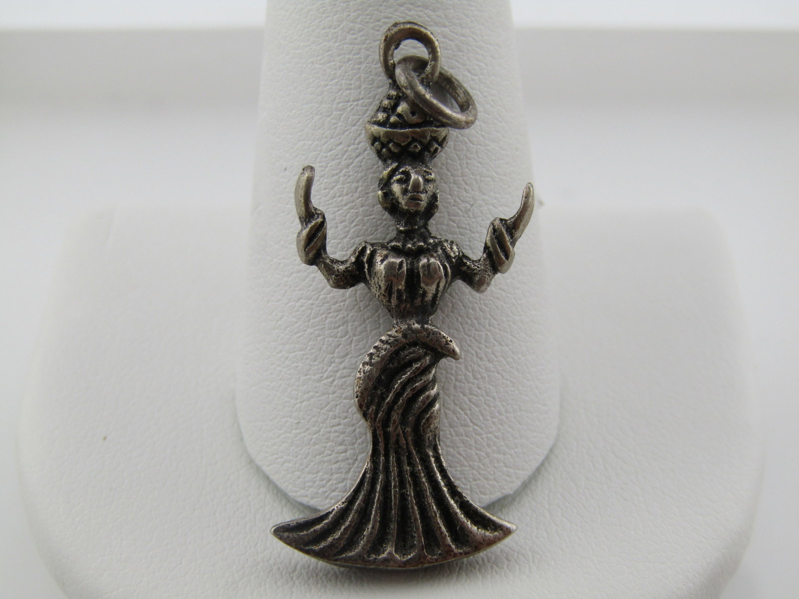 Vintage Sterling Afro-Colombian Woman Charm/Pendant, with Basket on Head, Mid-Century: Vintage Sterling Afro-Colombian Woman Charm/Pendant, with Basket on Head, Mid-Century. This is a woman with a long flared out skirt and hands pointed upward carrying a baset on her head. It is appx.