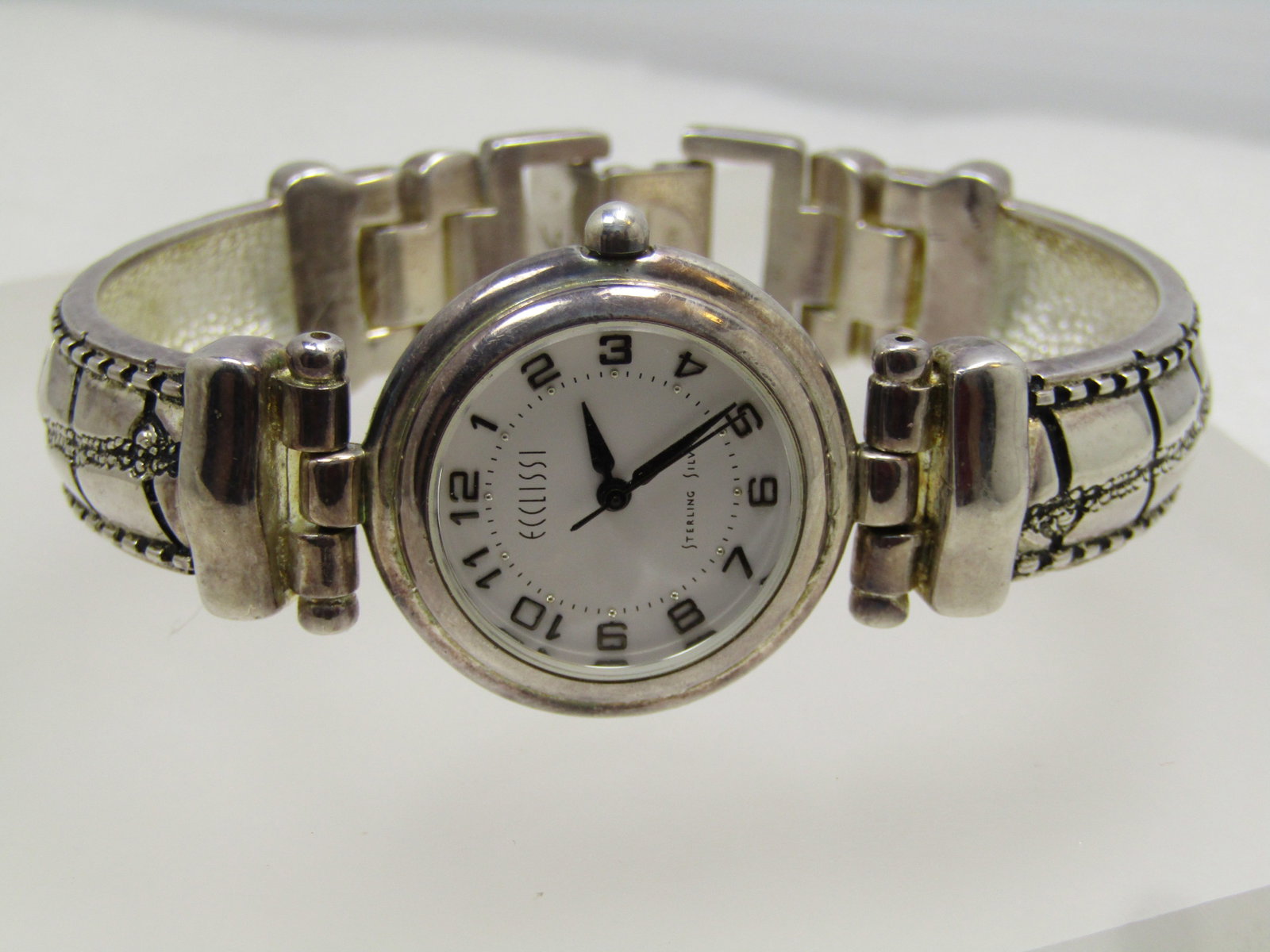 Sterling Silver Ecclissi ladies' Bracelet Watch, 6.75", 1990's, Runs: Sterling Silver Ecclissi ladies' Bracelet Watch, 6.75", 1990's, Runs. This is marked sterling silver and tests as sterling silver, black hands and secnd hand. Numbers 1 through 12 are also in black.
