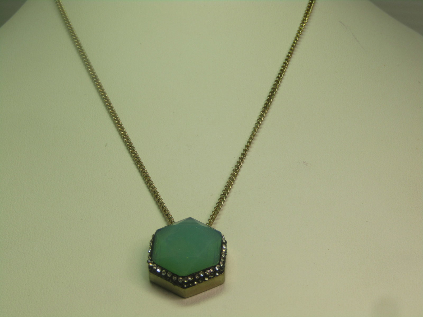 Faceted Green Glass and Black/Clear Rhinestone Necklace, 20", 1990's: Faceted Green Glass and Black/Clear Rhinestone Necklace, 20", 1990's. Gold tone. This has a six-sided pendant with a faceted opally green glass stone that is set in a bezel with a row of clear and
