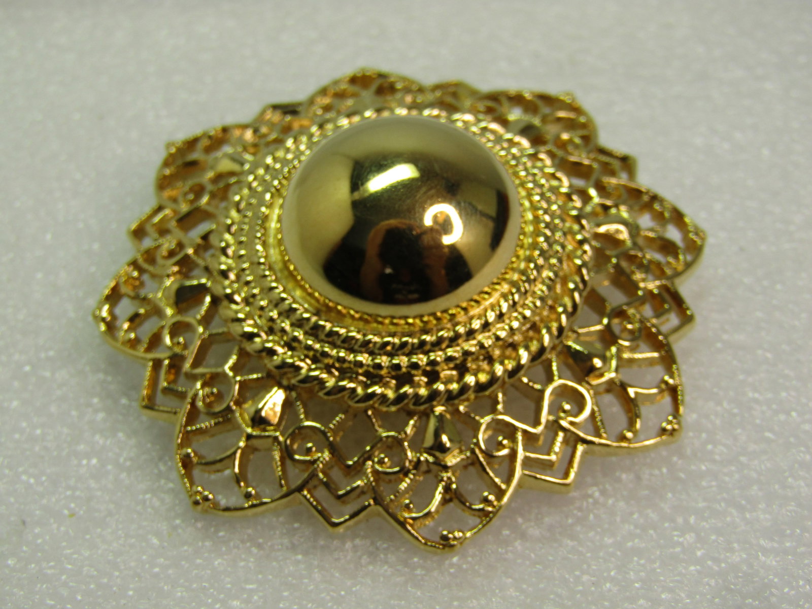 Vintage Trifari Fiigree Domed Brooch, 1970's-1980's: Vintage Trifari Fiigree Domed Brooch, 1970's-1980's. This is gold tone and both textured and polished, with with a fiiligree outer rim and rope accent tiers and a larged round domed center. The brooch