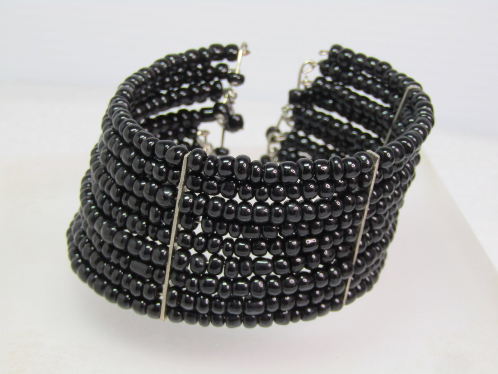 Vintage Black Glass Coiled Wrapped Bracelet, with Dangles, Style 6"-8". 1970's-1980's: Vintage Black Glass Coiled Wrapped Bracelet, with Dangles, Style 6"-8". 1970's-1980's This will fit almost any wrist because it opens at the back and slips on easy and expands easily. This has nine