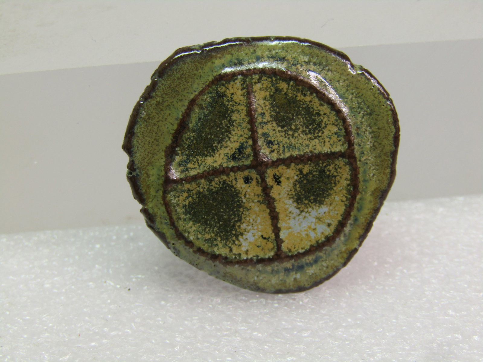 Vintage Clay Glazed Handmade Brooch, 1980's-1990's: Vintage Clay Glazed Handmade Brooch, 1980's-1990's. Glazed on a multi shaded green glase with creamy accents - the design is a raised circle with a horizontal and vertial line through the centers