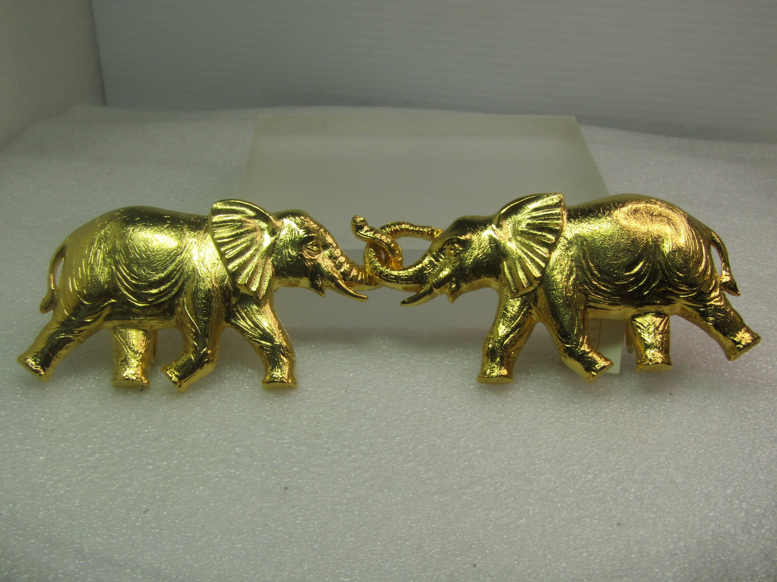 Vintage Interlocking Elephant Buckle Set, Dotty Smith Tag 1970's-1980's: Vintage Interlocking Elephant Buckle Set, Dotty Smith Tag 1970's-1980's. Large textured gold tone elephants with one elephant having a closed loop trunk and the other open to slip through the other el