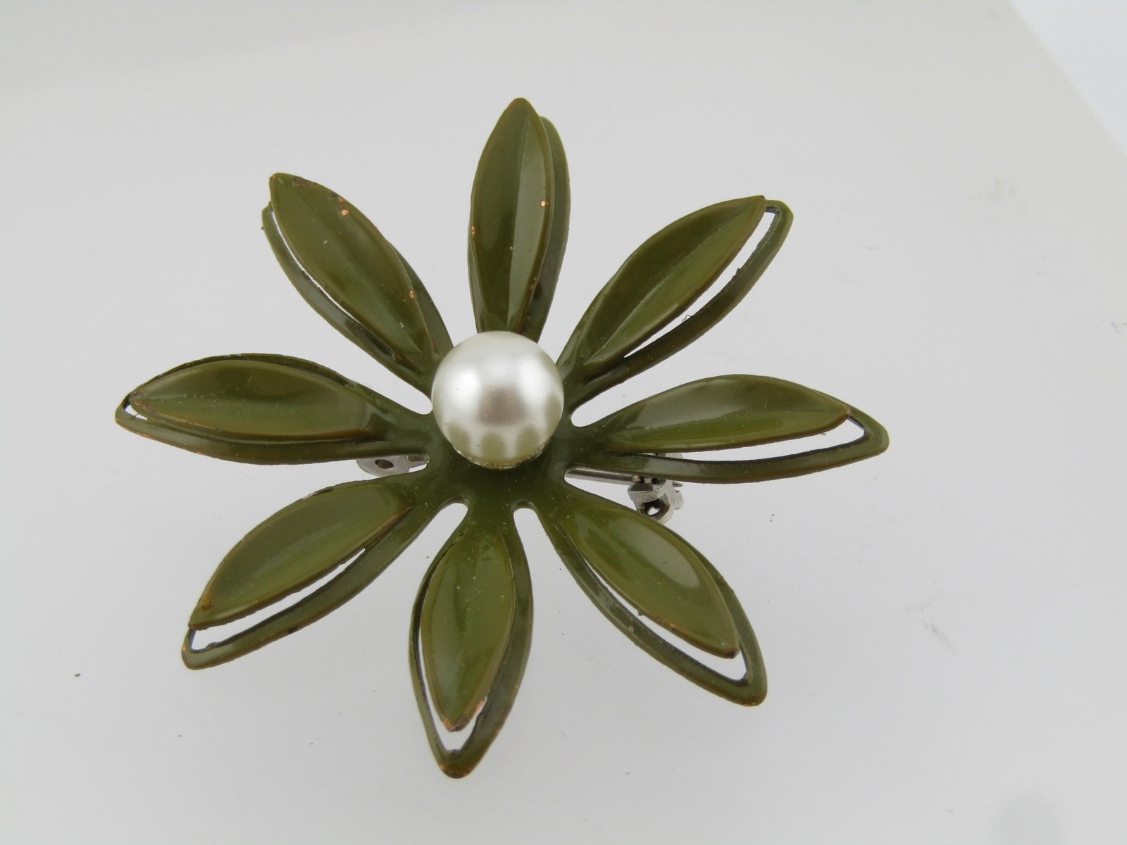 Vintage Green Enameled Floral Brooch With Faux Pearl, 1960's: Vintage Green Enameled Floral Brooch With Faux Pearl, 1960's. This is appx. 1-7/8". Enameled in olive green with an outline lower petal and solid upper petal with a tapered design to the leaf. The fau