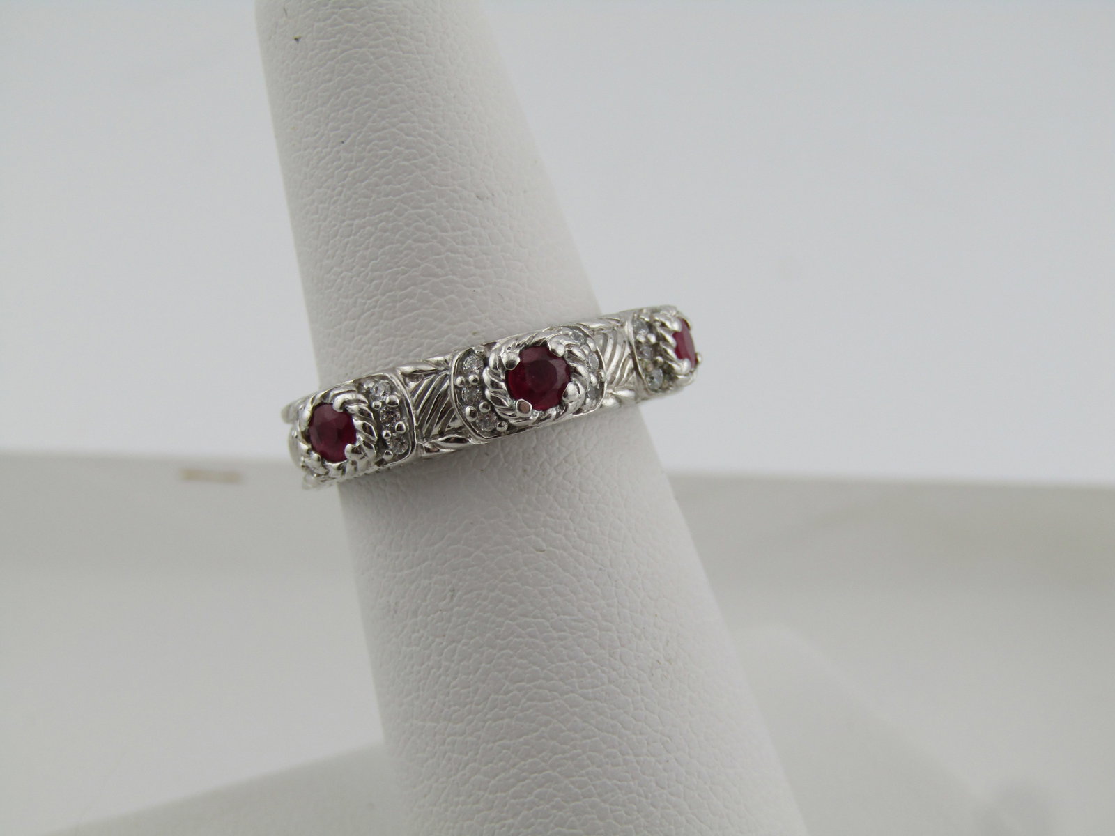Judith Ripka Sterling Ruby and CZ Ring, Sz. 6.25, 1980's-1990's: Judith Ripka Sterling Ruby and CZ Ring, Sz. 6.25, 1980's-1990's. This is appx. 5mm on top and 4.5mm at the back of the finger. It has three round cut rubies that are appx. 2.5mm set in slightly raised