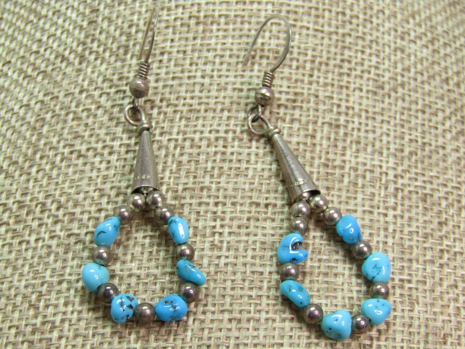 Vintage Sterling Southestern Turquoise Hoop Earrings, Drop, 1970's-1980's: Vintage Sterling Southestern Turquoise Hoop Earrings, Drop, 1970's-1980's. The earrings have hook posts that are marked .925 with a drop of sterling and turquoise beads in a hoop with a conical sterli