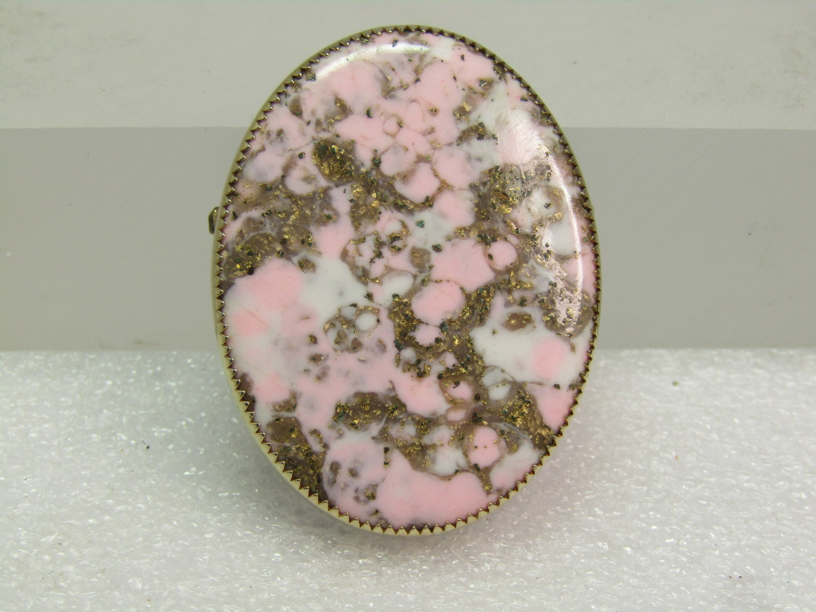 Vintage Pink/White/Gold Stone Brooch, Oval, 1960's-1970's: Vintage Pink/White/Gold Faux Agate Brooch, Oval, 1960's-1970's. This has a sawtooth bezel-setting around the oval stone that is appx. 1-5/8" by 1.25". Gold tone with locking clasp. It is not marked or