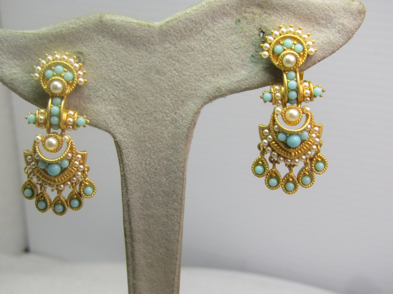 Faux Turquoise and Pearl Clip Earrings, Signed Phillip Bloch, 2000's: Faux Turquoise and Pearl Clip Earrings, Signed Phillip Bloch, 2000's. Gold tone with a glamorous design with small faux seed pearls and small snake-eye faux turquoise. The top partacts like a stud wit