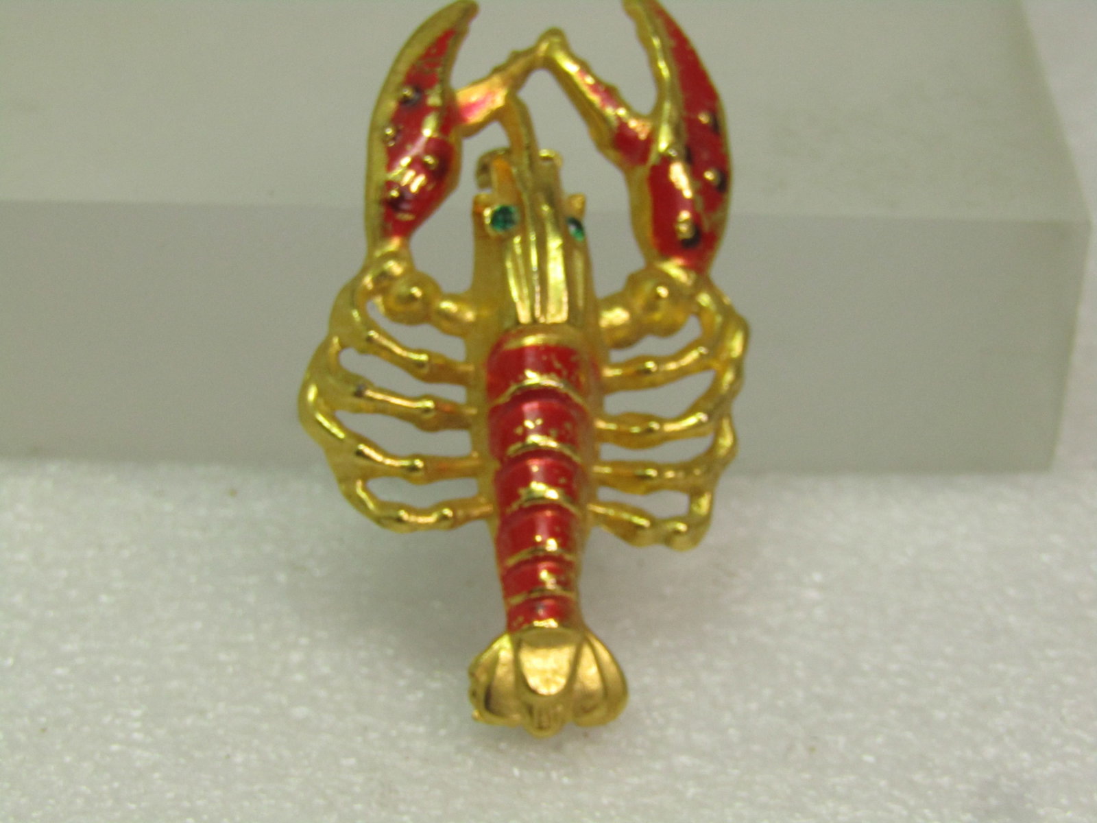 Vintage Red Enameled Lobster Brooch, 1950's: Vintage Red Enameled Lobster Brooch, 1950's. Gold tone with red/orange enameled on the claws and shell. Green rhinestone eyes - greed detail - this is not a flat brooch but 3-d on top. It is appx.