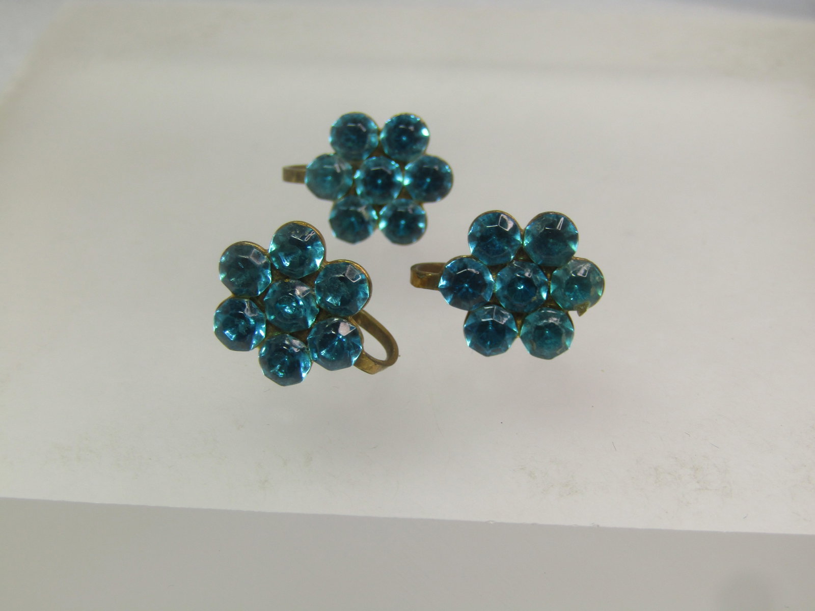 Vintage Aqua Rhinestone Blossom Earrings, Screwback (3 pieces), 1940's-1950's: Vintage Aqua Rhinestone Blossom Earrings, Screwback (3 pieces), 1940's-1950's. Three of the same earrings - I am sending the extra one along as back-up. Unfortunately the estate sale was missing the b