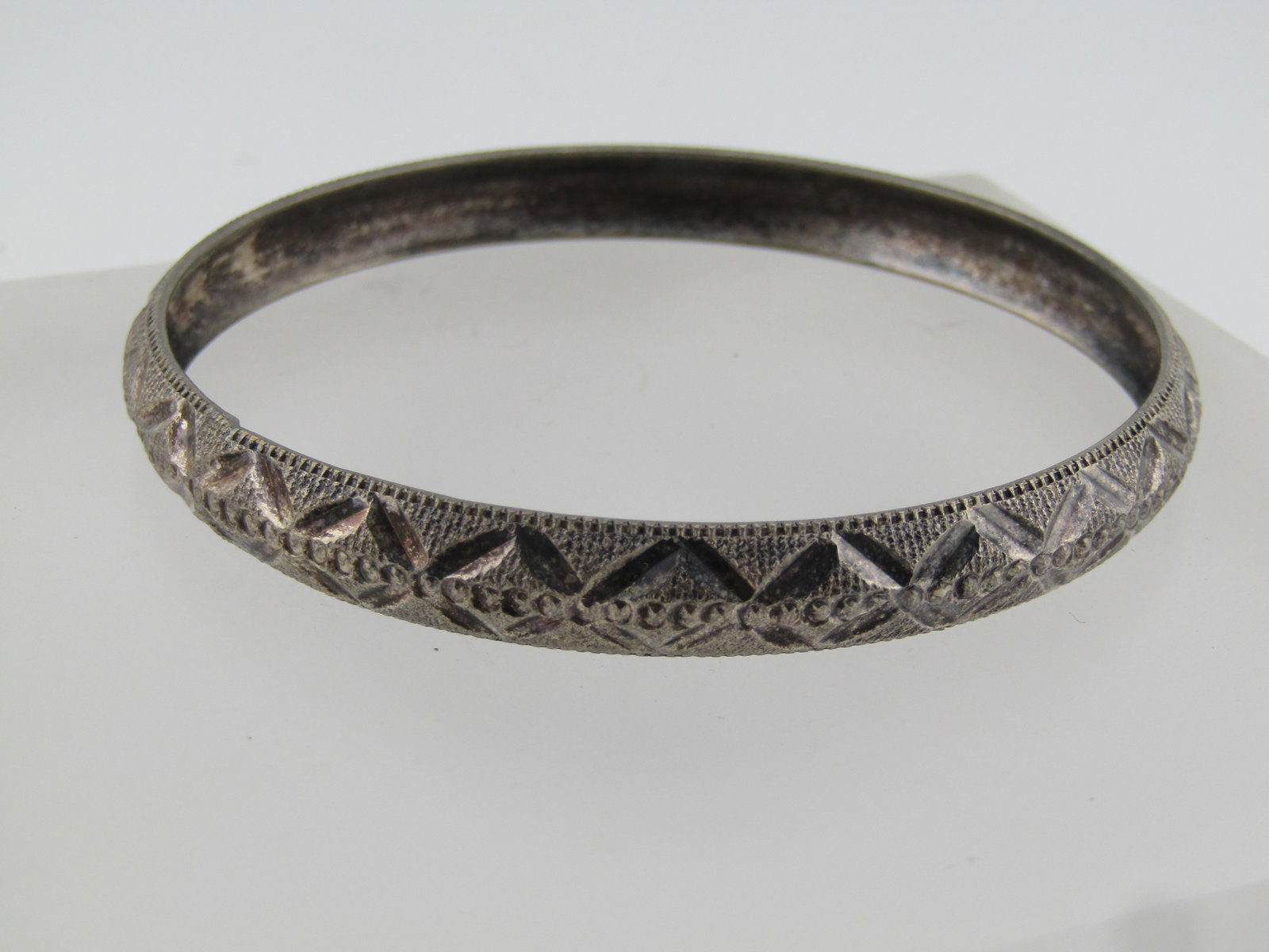 Vintage Silver Tone Cuff Bracelet, 8.25", Domed, 1970's-1980's: Vintage Silver Tone Cuff Bracelet, 8.25", Domed, 1970's-1980's. Large enough to be unisex. Almost 2.75" opening. Textured finish with domed edge and diamond cut accents. It is appx. 8mm wide. It is no