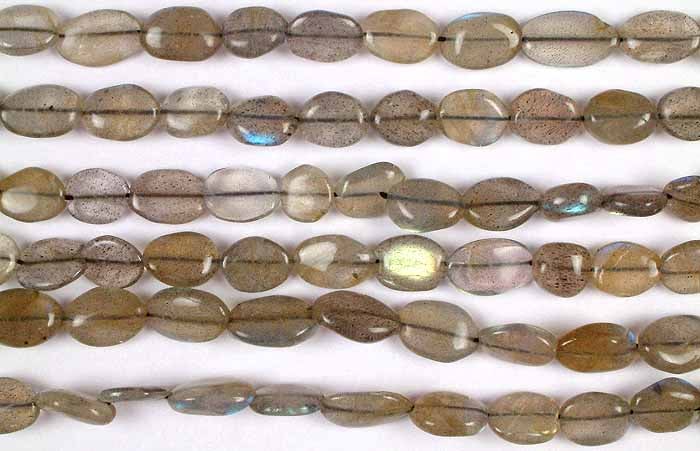 Labradorite Ovals / Semi-Precious Gemstone Beads: Title: Labradorite Ovals / Semi-Precious Gemstone Beads Description: The Labradorite Ovals, arranged in a string, are a mesmerizing addition to any jewelry piece. Labradorite, known for its iridescent