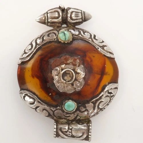 Tibetan Amber Silver Turquoise Pendant: Title:Tibetan Amber Silver Turquoise Pendant Size:2 in (5.1 cm) wide x 1 ½ in (3.8 cm) tall. Description:A rich and hand worked antique Tibetan pendant dating from circa 1900. A rounded disk
