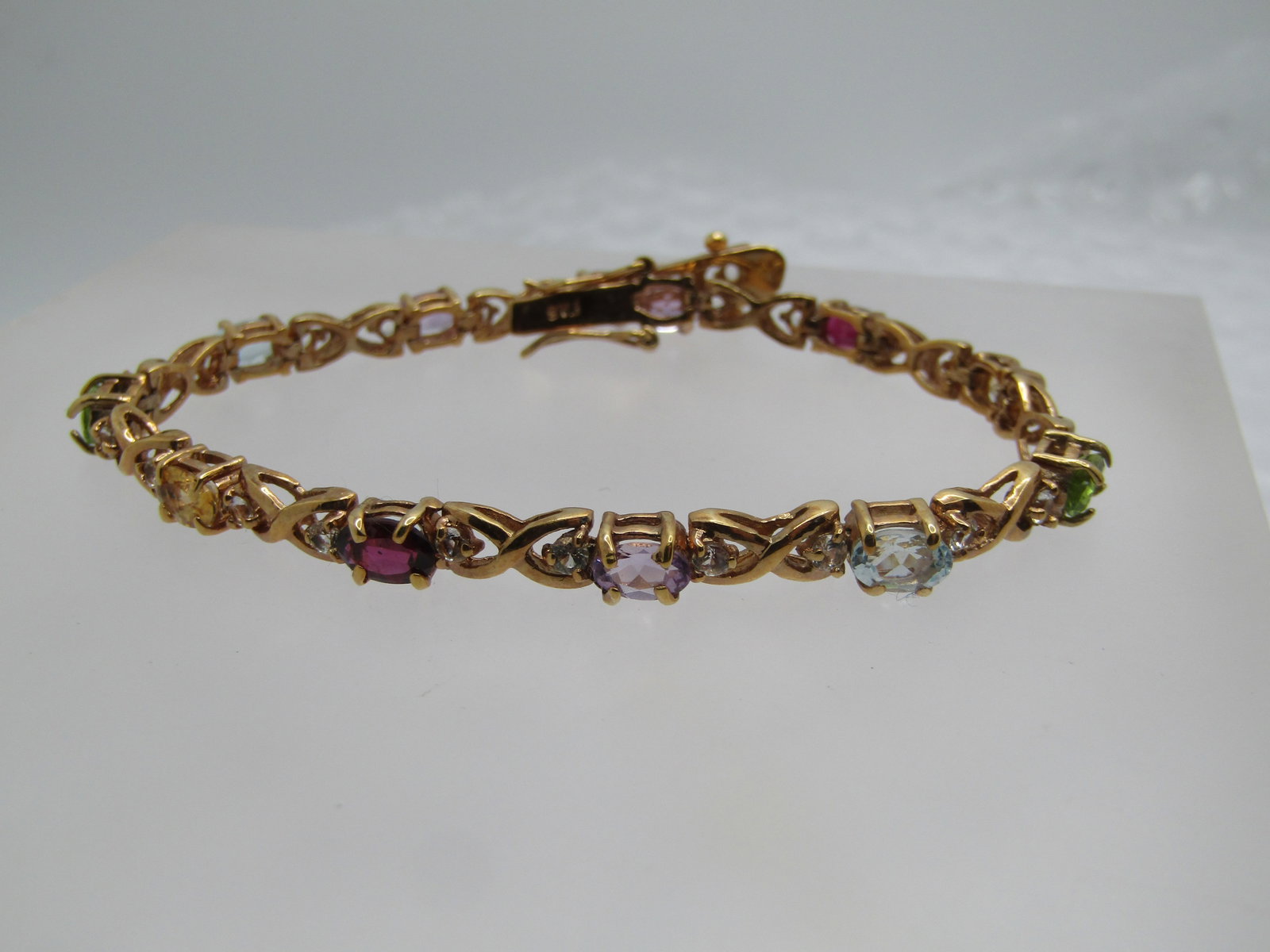 Vintage Vermeil Gemstone Tennis Bracelet, Signed FAS, 7.5": Vintage Vermeil Gemstone Tennis Bracelet, Signed FAS, 7.5". This has an X O (oval) design with oval gemstones in amethyst, garnet, topaz, citrine, peridot. The stones are appx. 5.5mm by 4mm. Between