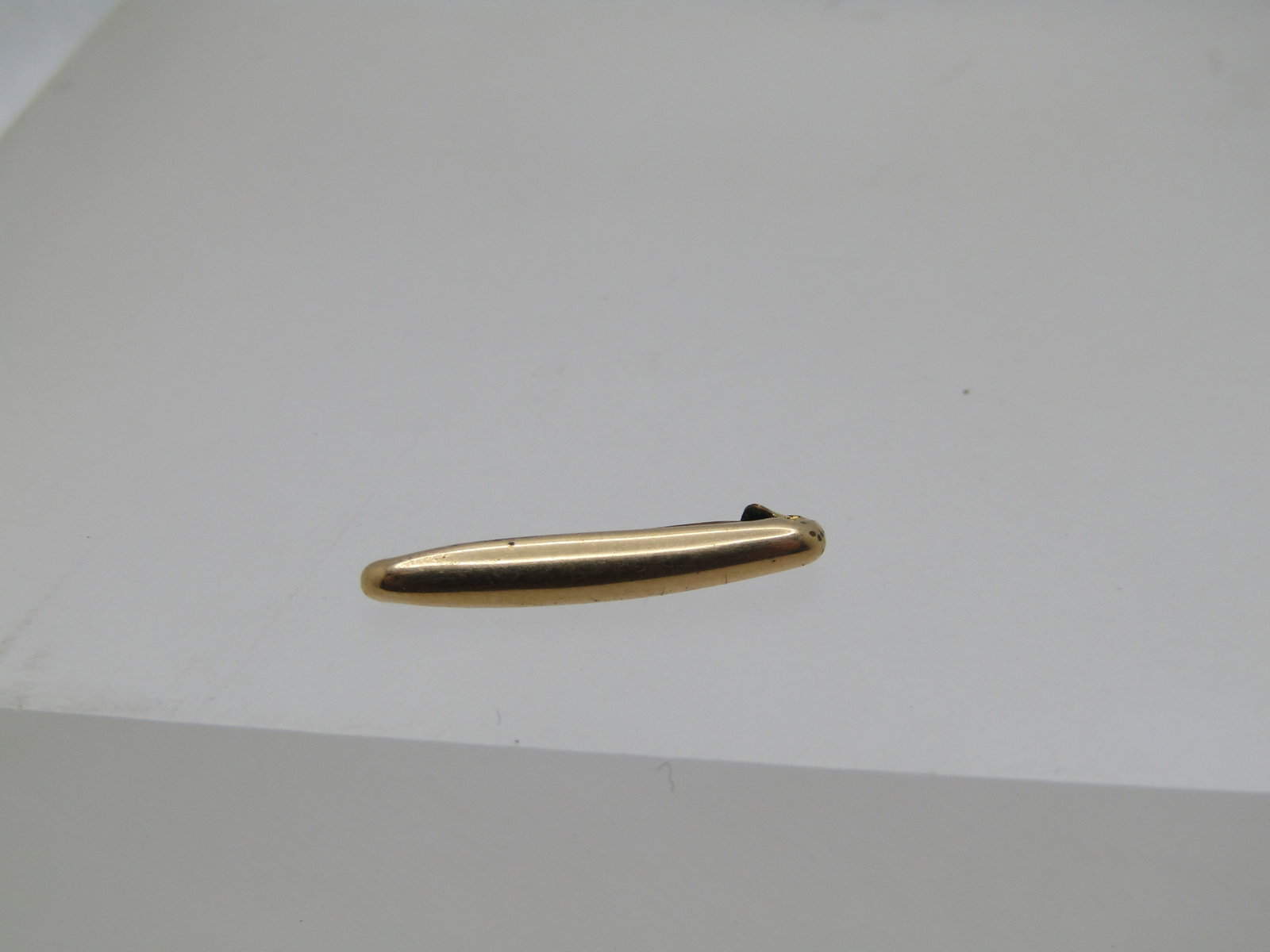 Vintage 10kt G.F. Small Brooch, C-Clasp, Early 1900's: Vintage 10kt G.F. Small Brooch, C-Clasp, Early 1900's - Petite oblong and slightly domed 10kt g.f. pin with c-clasp it is appx. .75" long and .11" wide. This is similar to lingerie pins that were sold